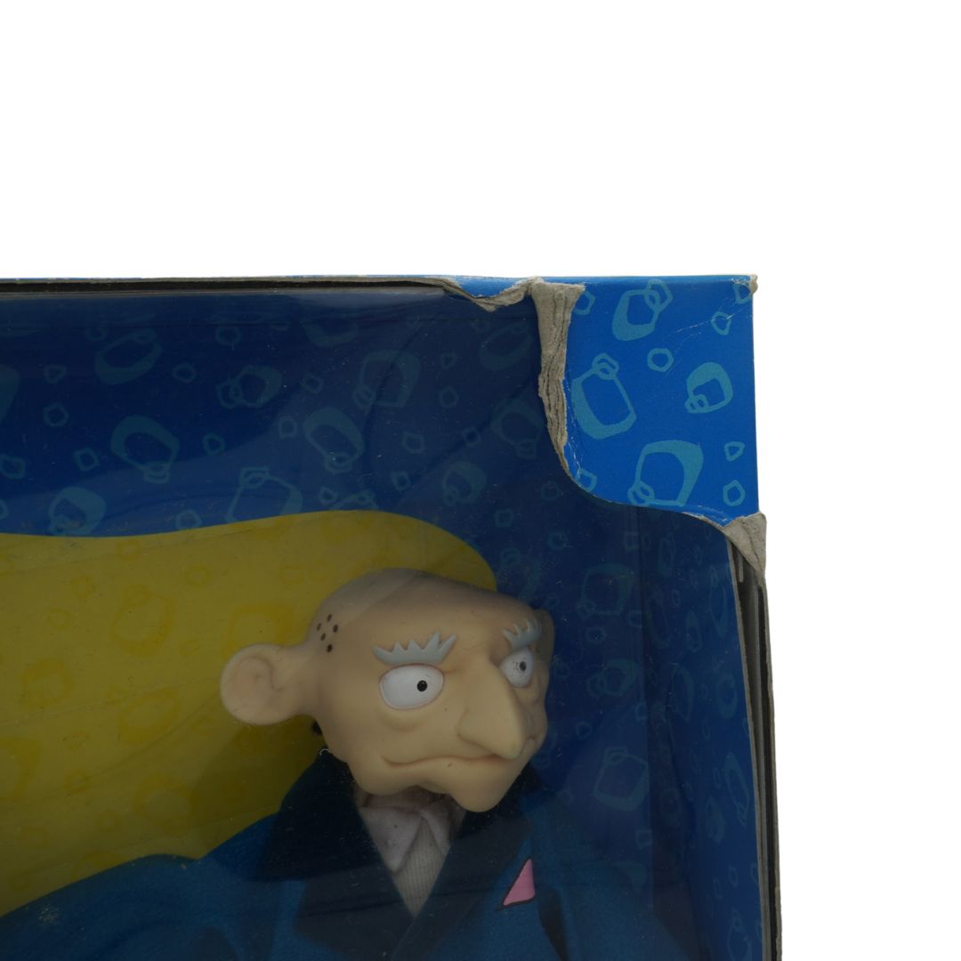 Cartoon character figure peeking out from a blue box with a yellow interior