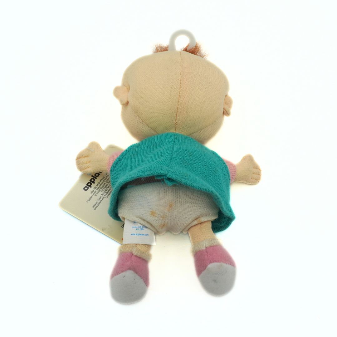 A vintage 1999 Nickelodeon Lil Deville plush from the Rugrats wearing a green shirt with pink shoes