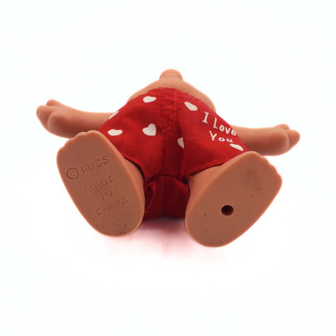 Toy figure wearing red shorts with 'I Love You' text on a white background