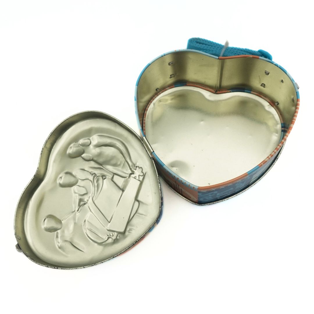 Inside of a 2003 tin heart shaped Saddle Club bag
