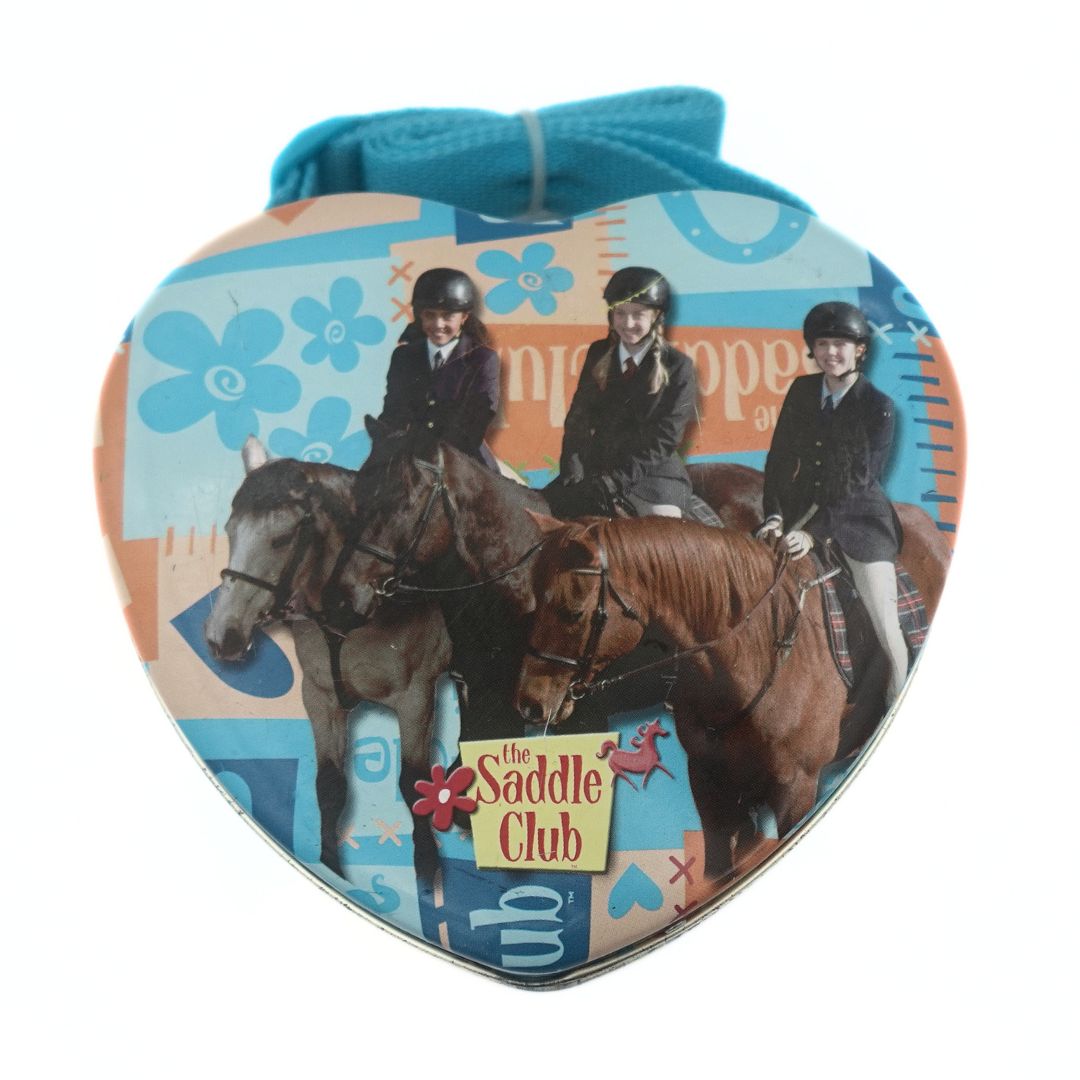 Heart shaped Saddle Club tin bag featuring Carole, Stevie and Lisa with a blue woven strap