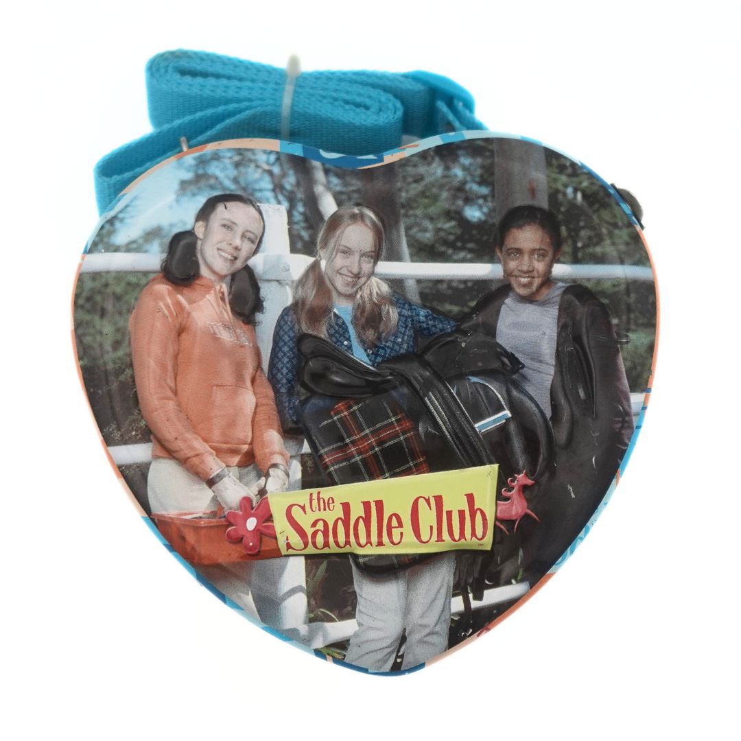 Heart shaped Saddle Club tin bag featuring Carole, Stevie and Lisa with a blue woven strap