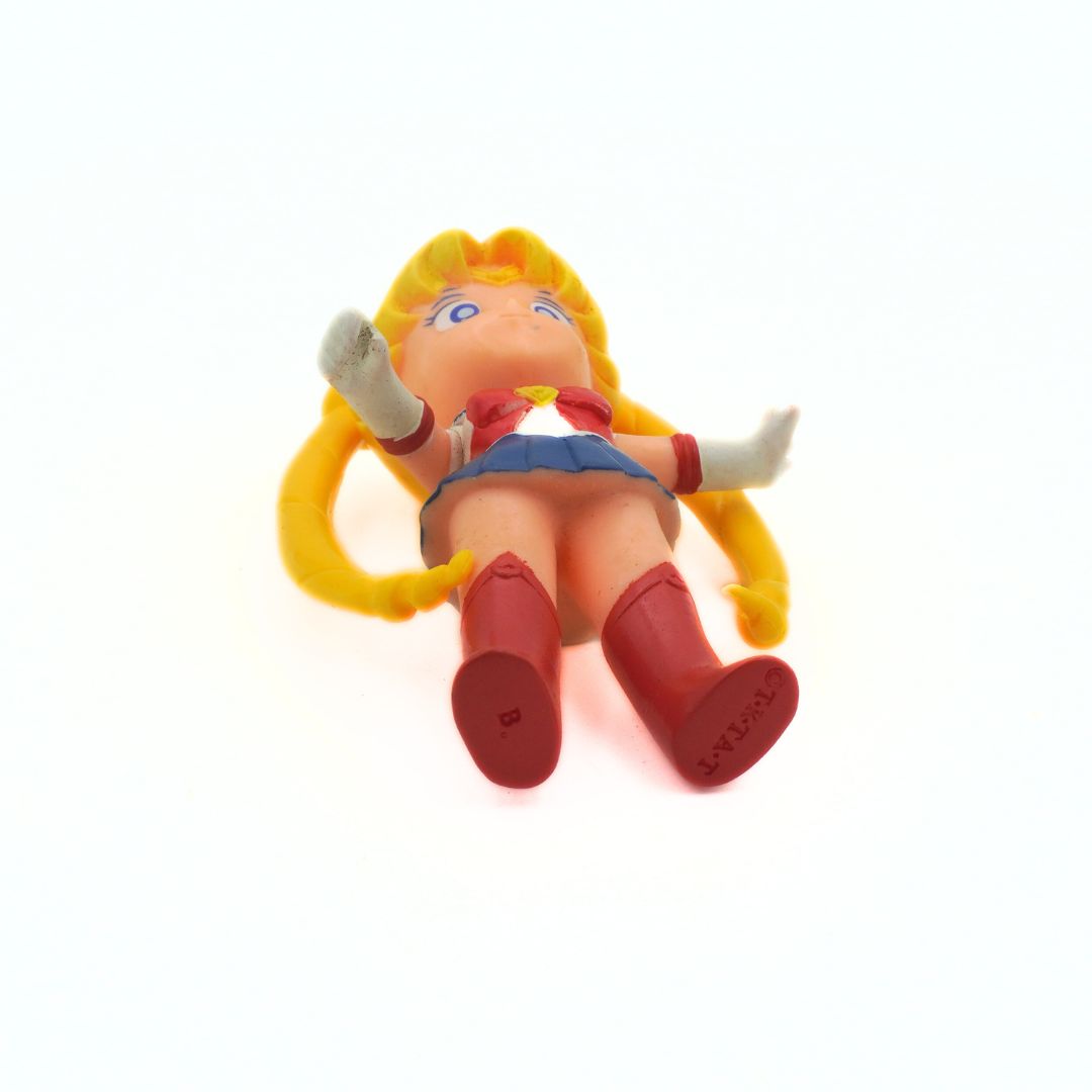 Underside of a vintage Sailor Moon figurine showing the branding debossed under the shoe