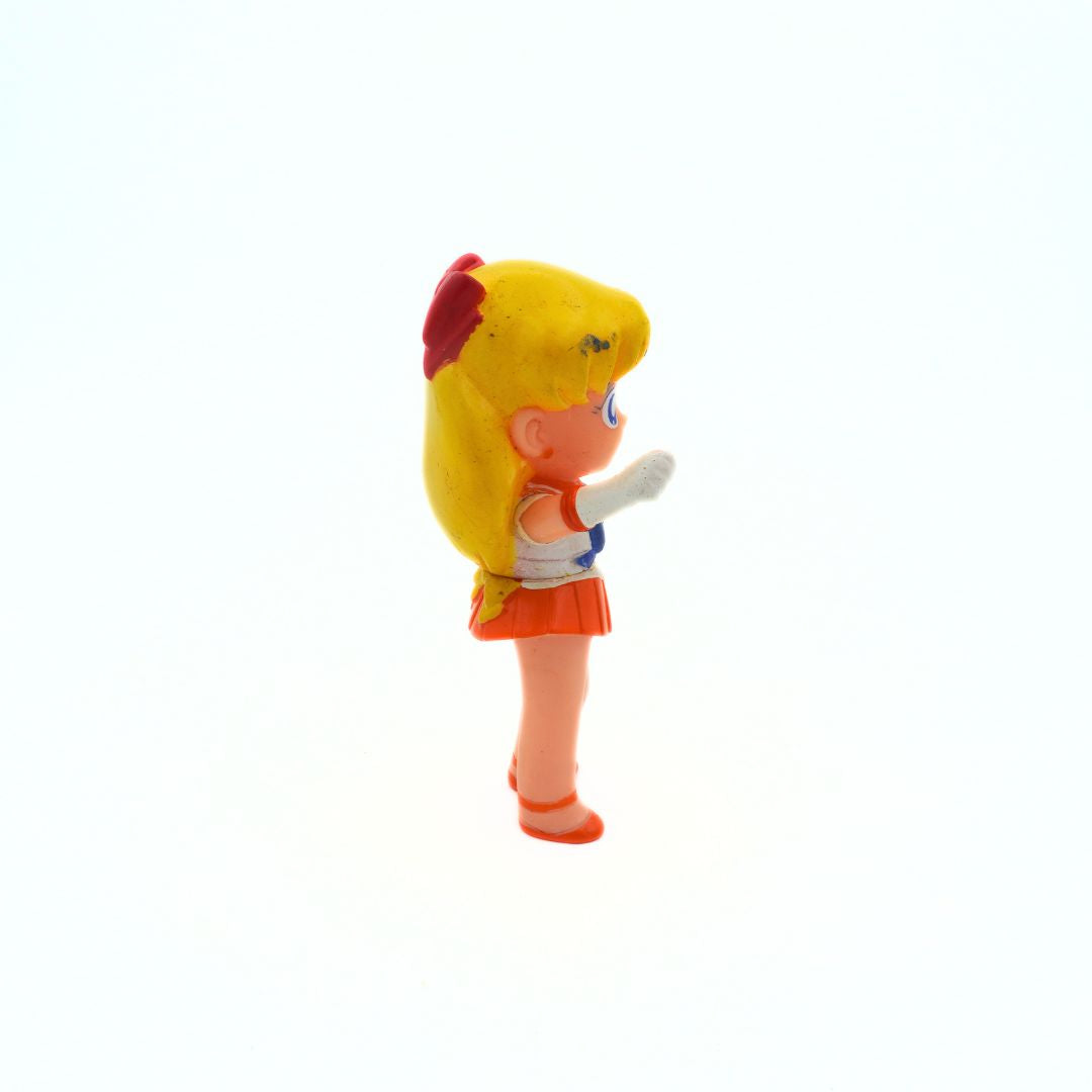 Side on photo of a vintage Sailor Moon Sailor Venus figurine showing some marks to the hair