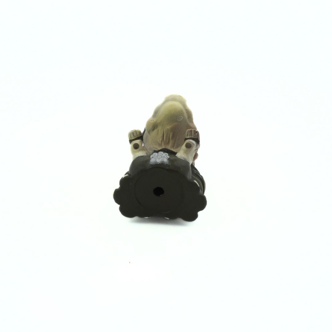 Underside of a 90s Star Wars Phantom Menace Sebulba keychain, with him wearing his podracing outfit