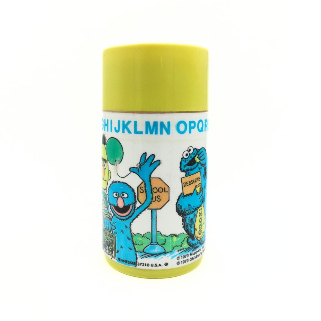 1979 Aladdin Sesame Street thermal flask showing Cookie Monster eating from a bag of cookies