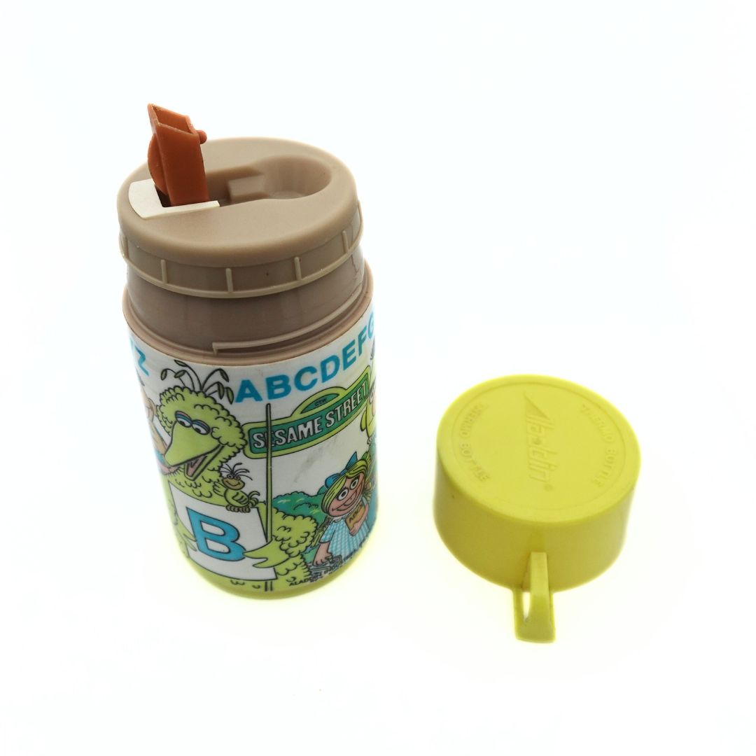 Photo showing the straw on a yellow Sesame Street thermal flask released by Aladdin in 1979
