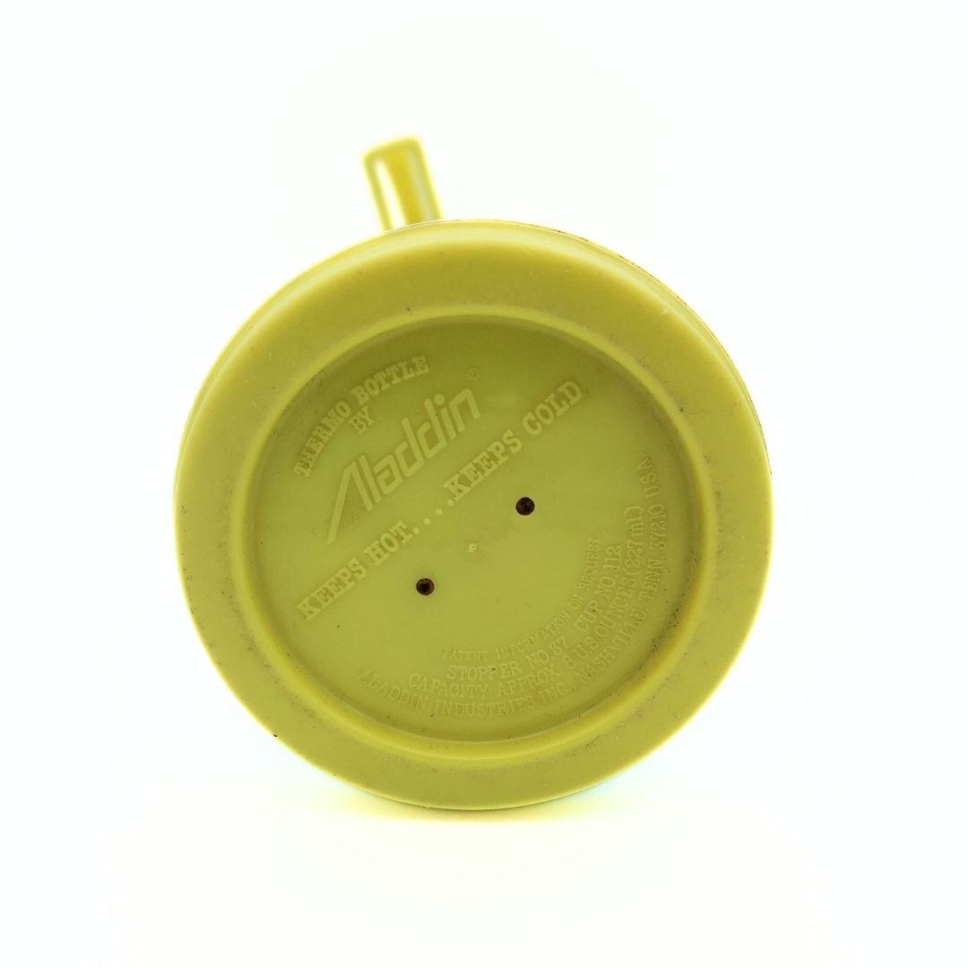 Underside of a 1979 thermo bottle with a yellow Sesame Street theme