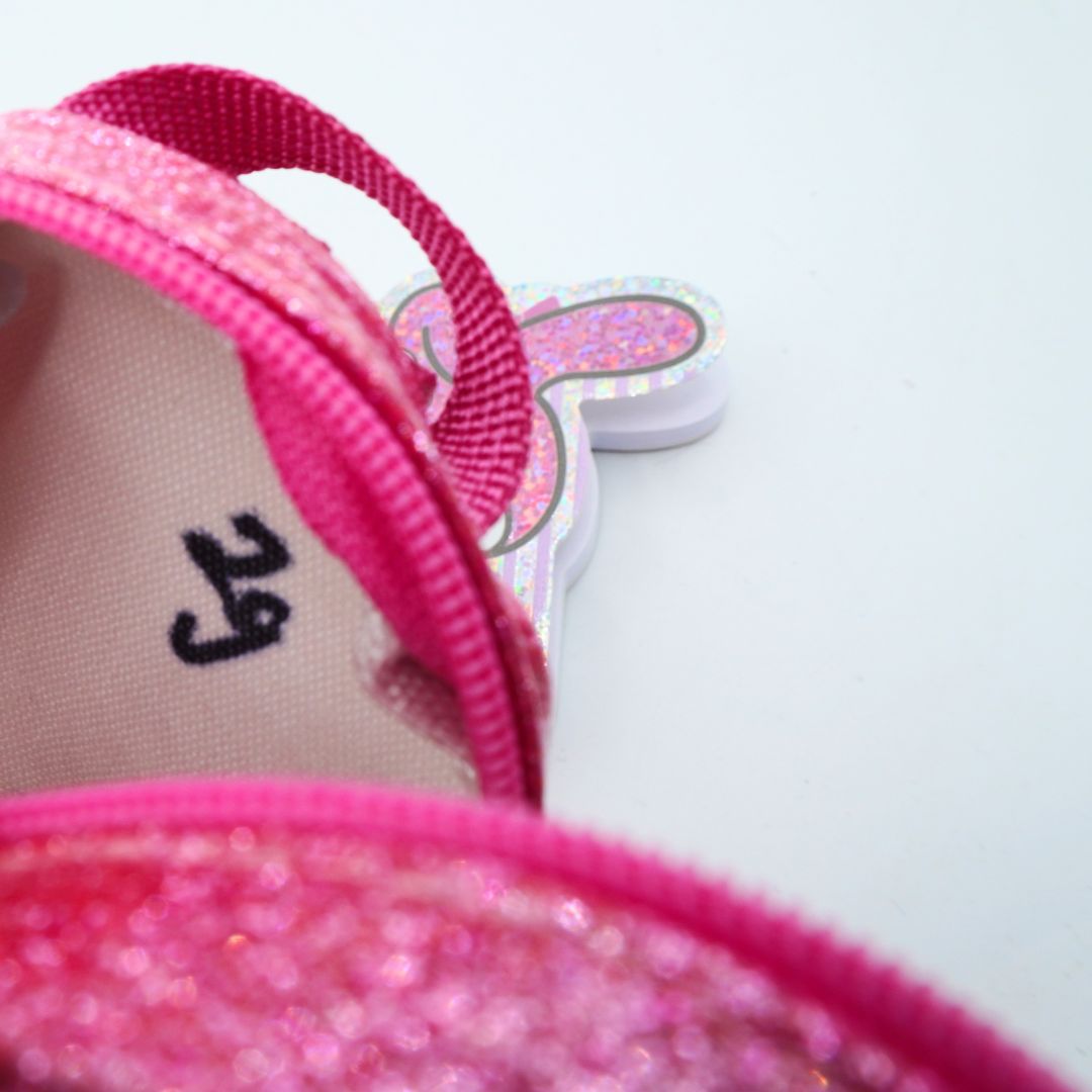Inside of a pink backpack showing black pen marks
