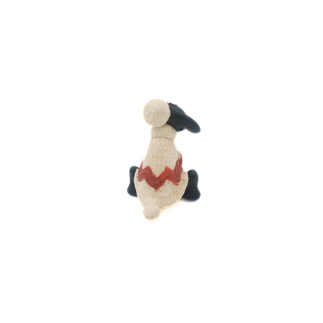 Back on photo of Shaun the Sheep from the Wallace & Gromit film series wearing a white and red sweater