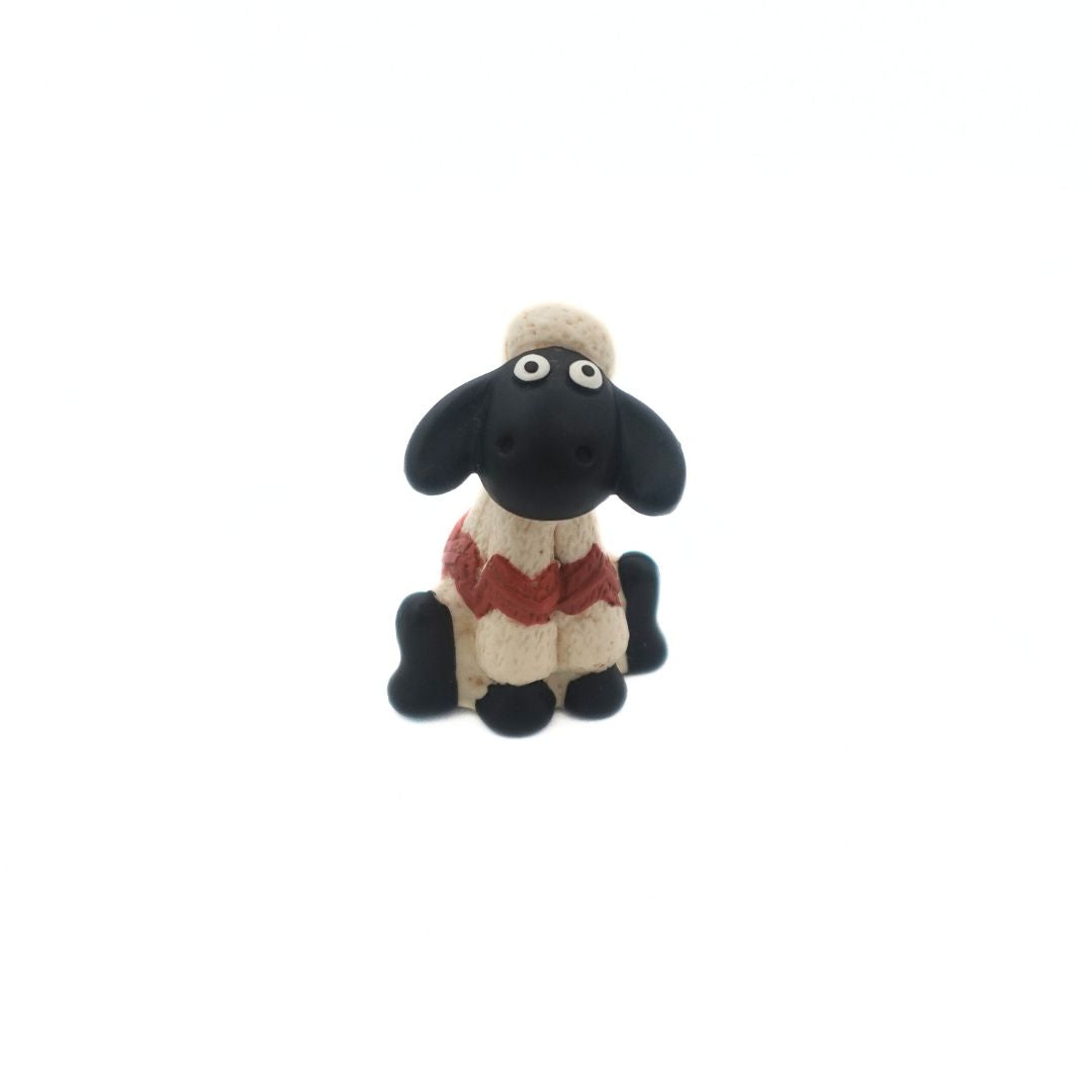 Shaun the Sheep from the Wallace & Gromit film series wearing a white and red sweater
