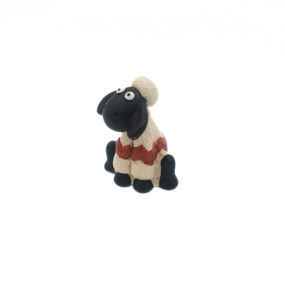 Shaun the Sheep from the Wallace & Gromit film series wearing a white and red sweater