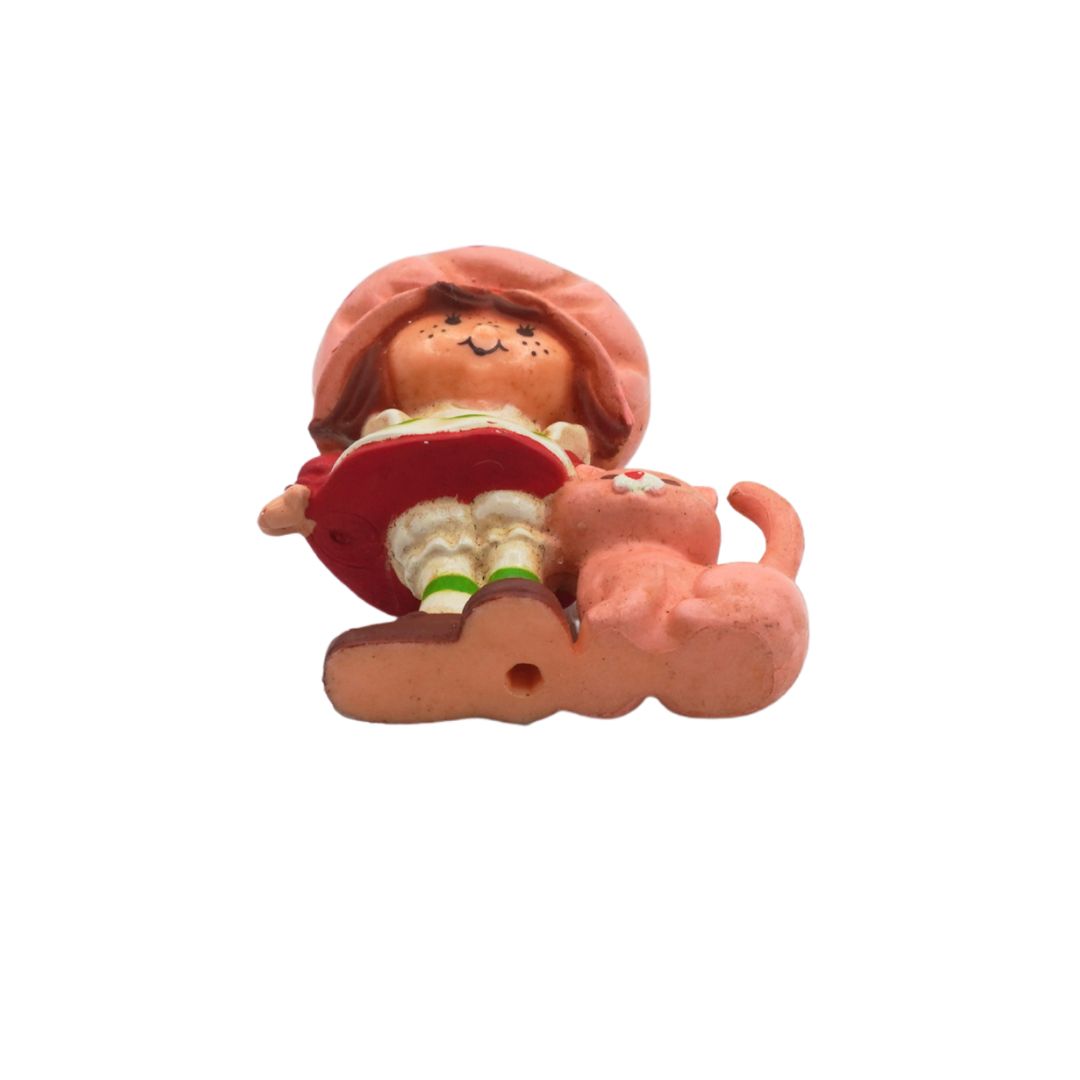Small figurine of a character sitting on a cloud with a red umbrella