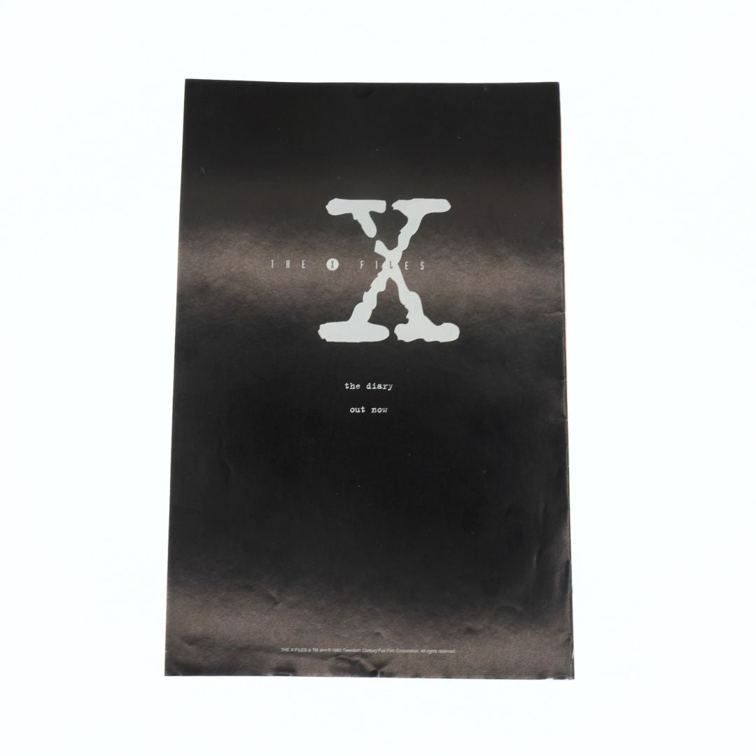 Black book cover with white 'X' design and text on a white background