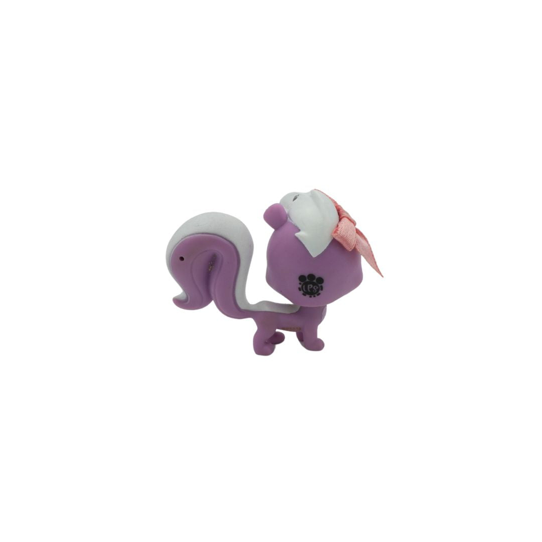 Purple and white figurine with a pink bow on a white background
