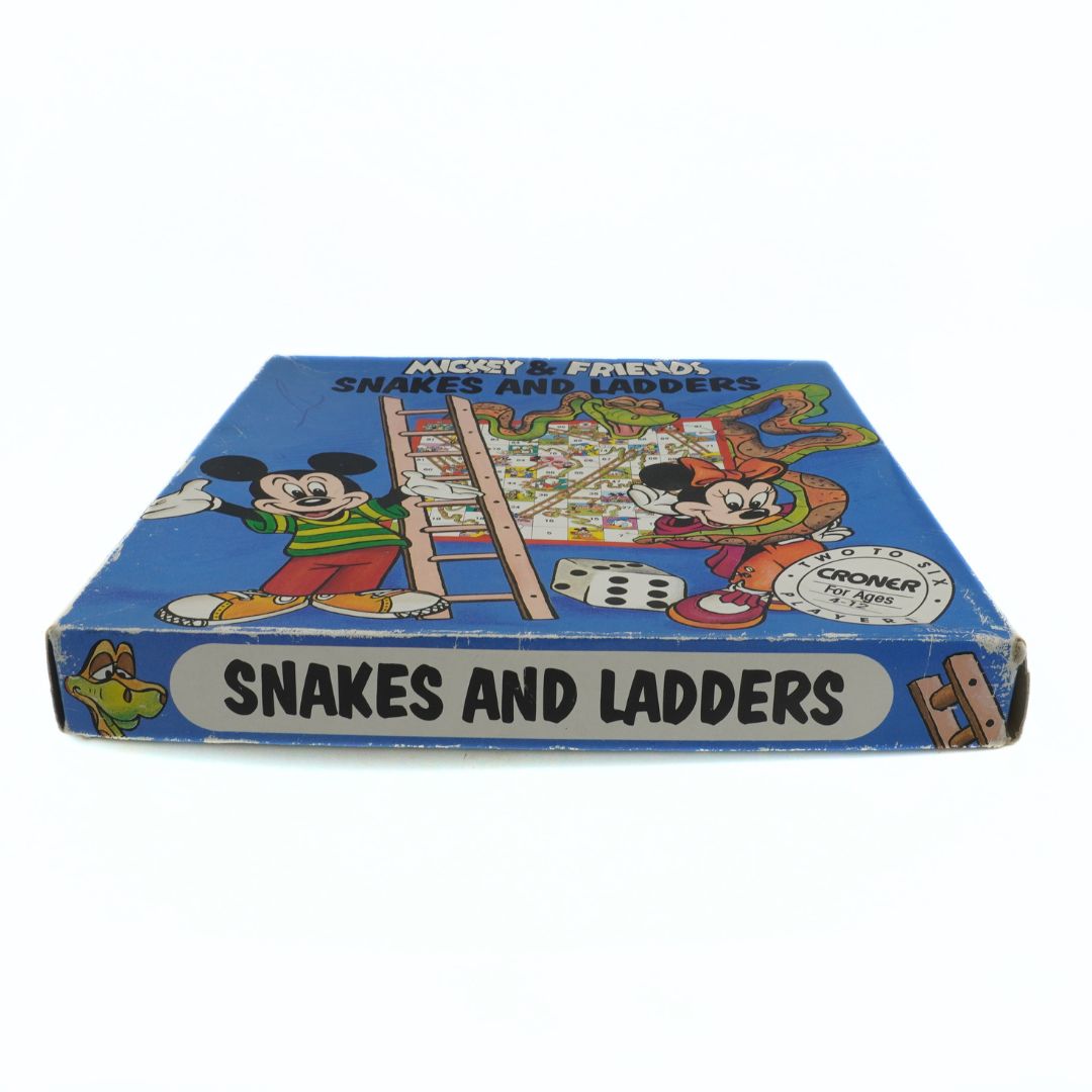 Side on photo of a vintage Croner Disney Mickey & Friends Snakes and Ladders board game