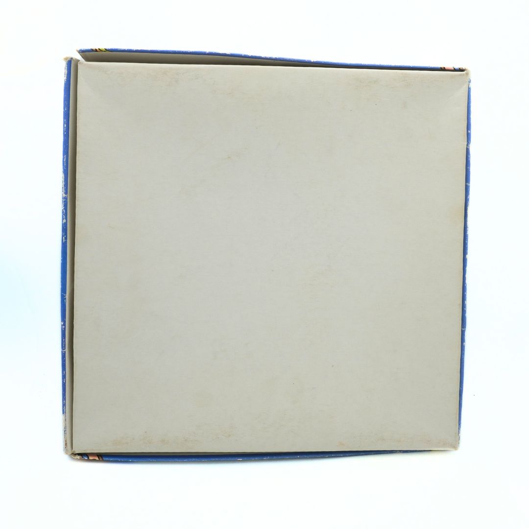 Back of a vintage Disney Snakes & Ladders game with a white base and blue lid