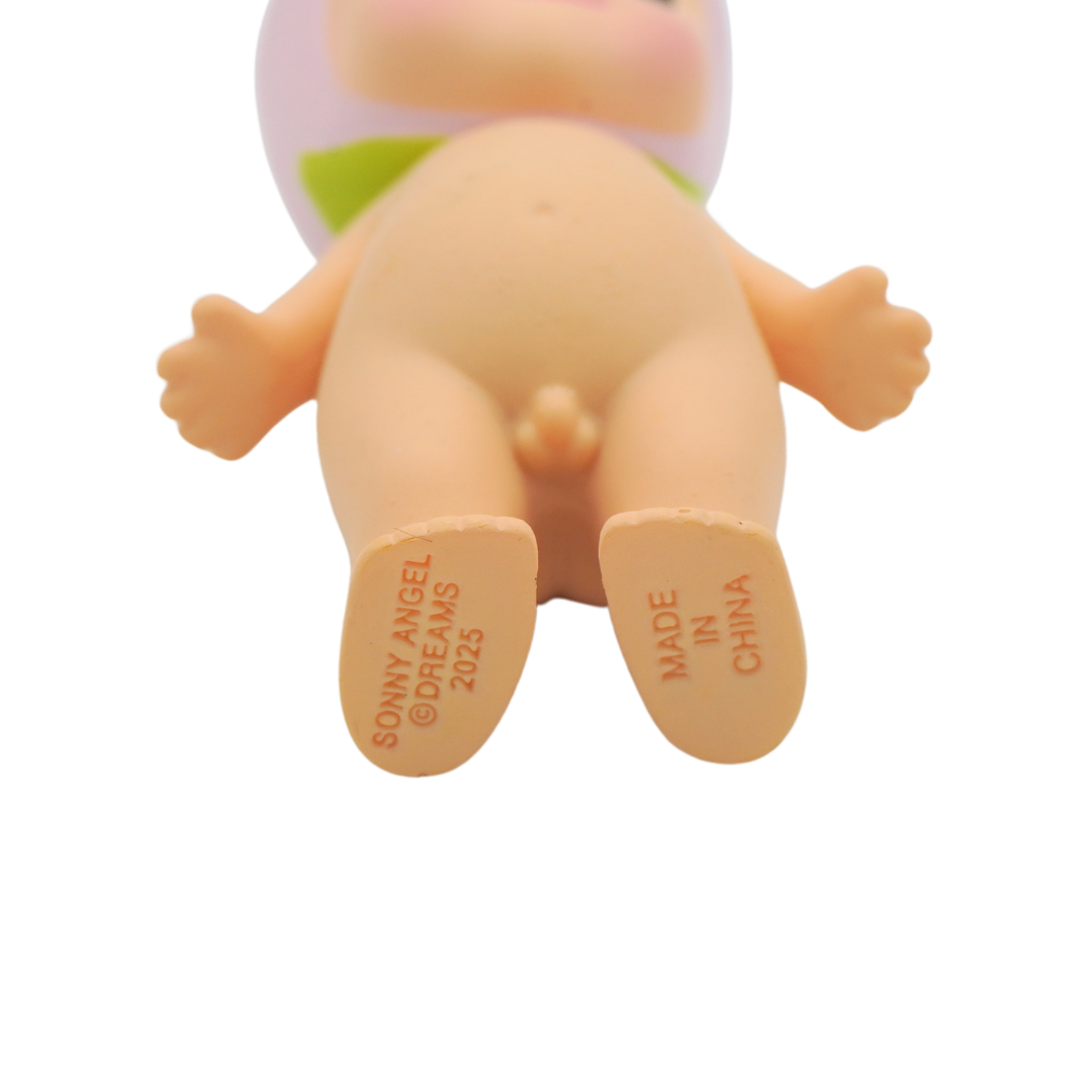 A peach themed Sonny Angel with a light pink peach hat, photographed on a white background.