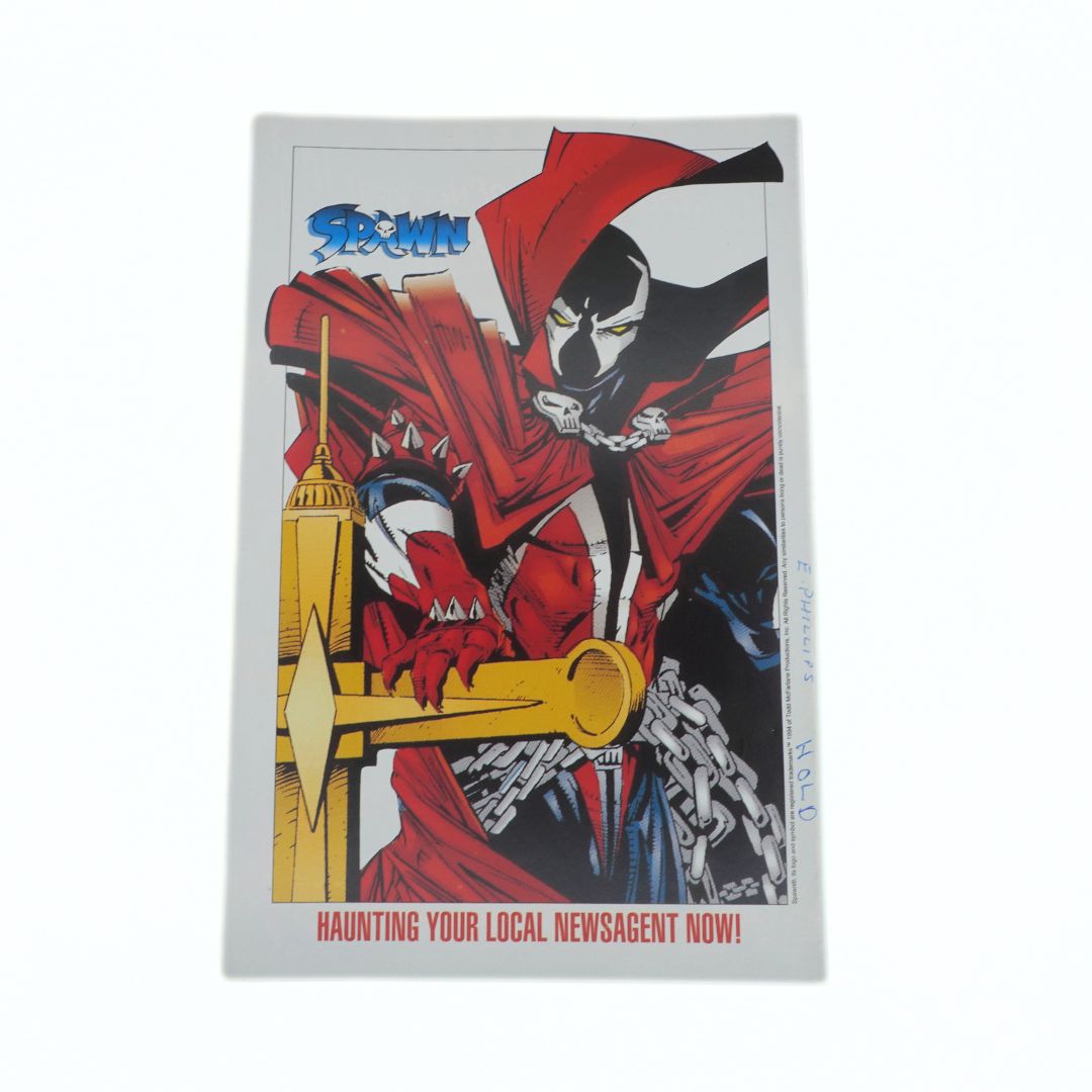 Comic book cover with a character in red and black attire holding a key, with 'Spawn' logo above.