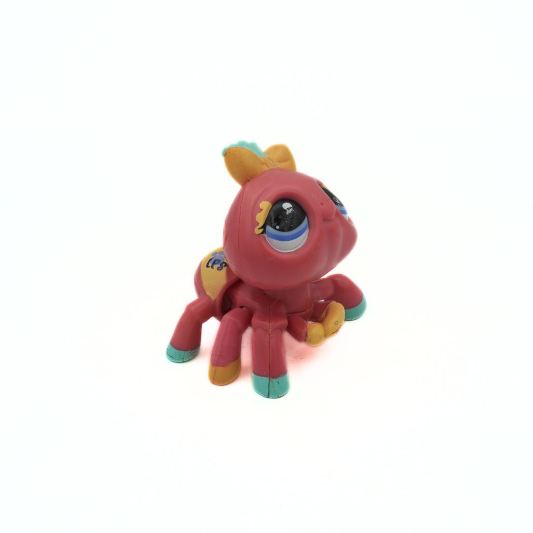 Colourful toy spider on a white background