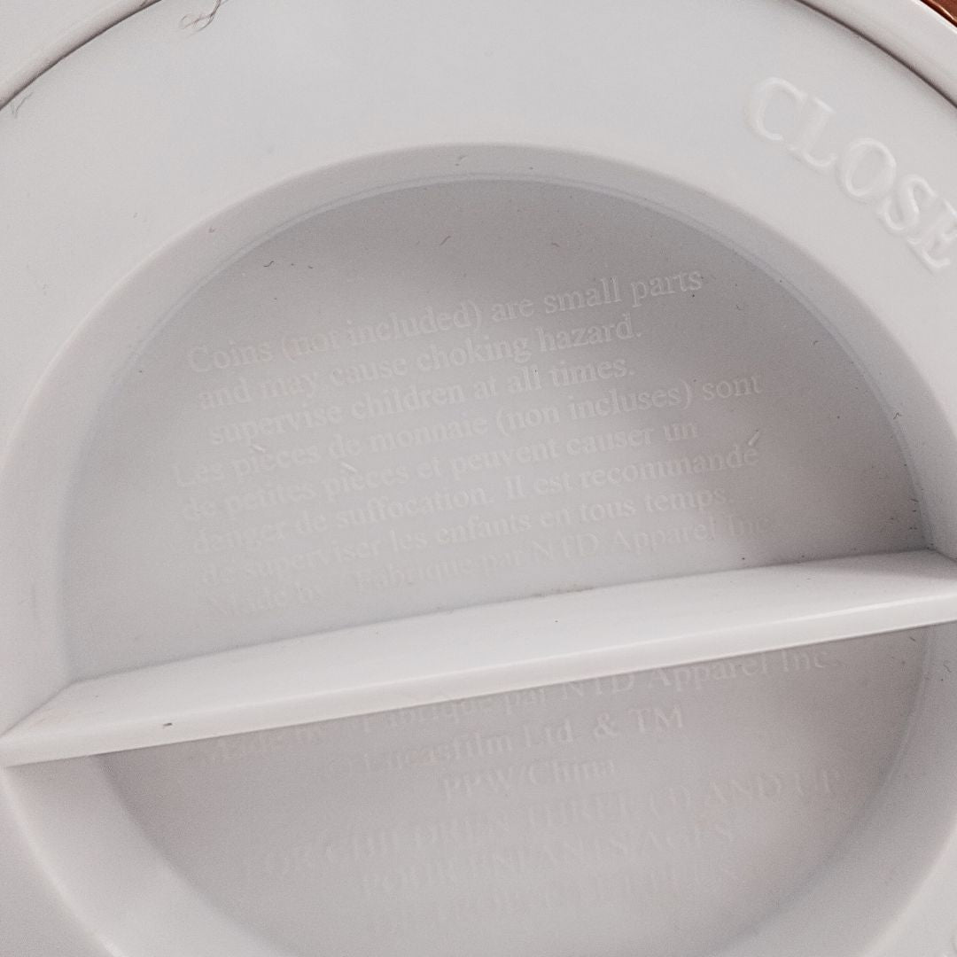 Copyright and safety information on the base of a 1999 Star Wars Young Anakin money box