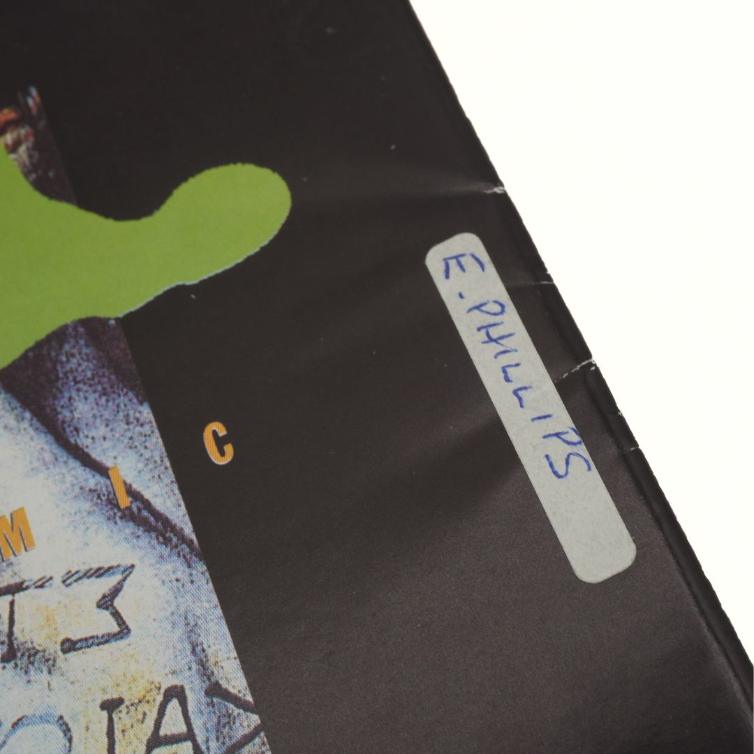 Close up of a hand written name on a sticker on the back of a vintage 90s Star Wars comic