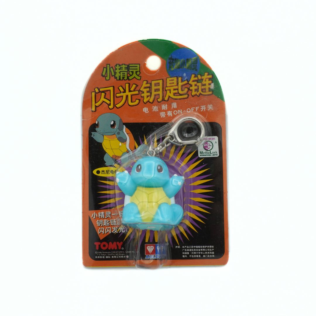 Tomy toy turtle keychain in packaging with Chinese text