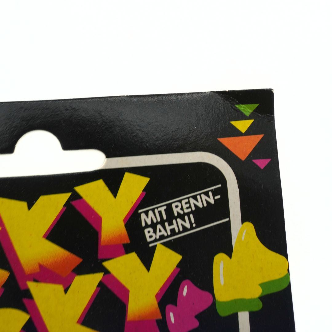 Close-up of a product packaging with colorful text and graphics on a white background