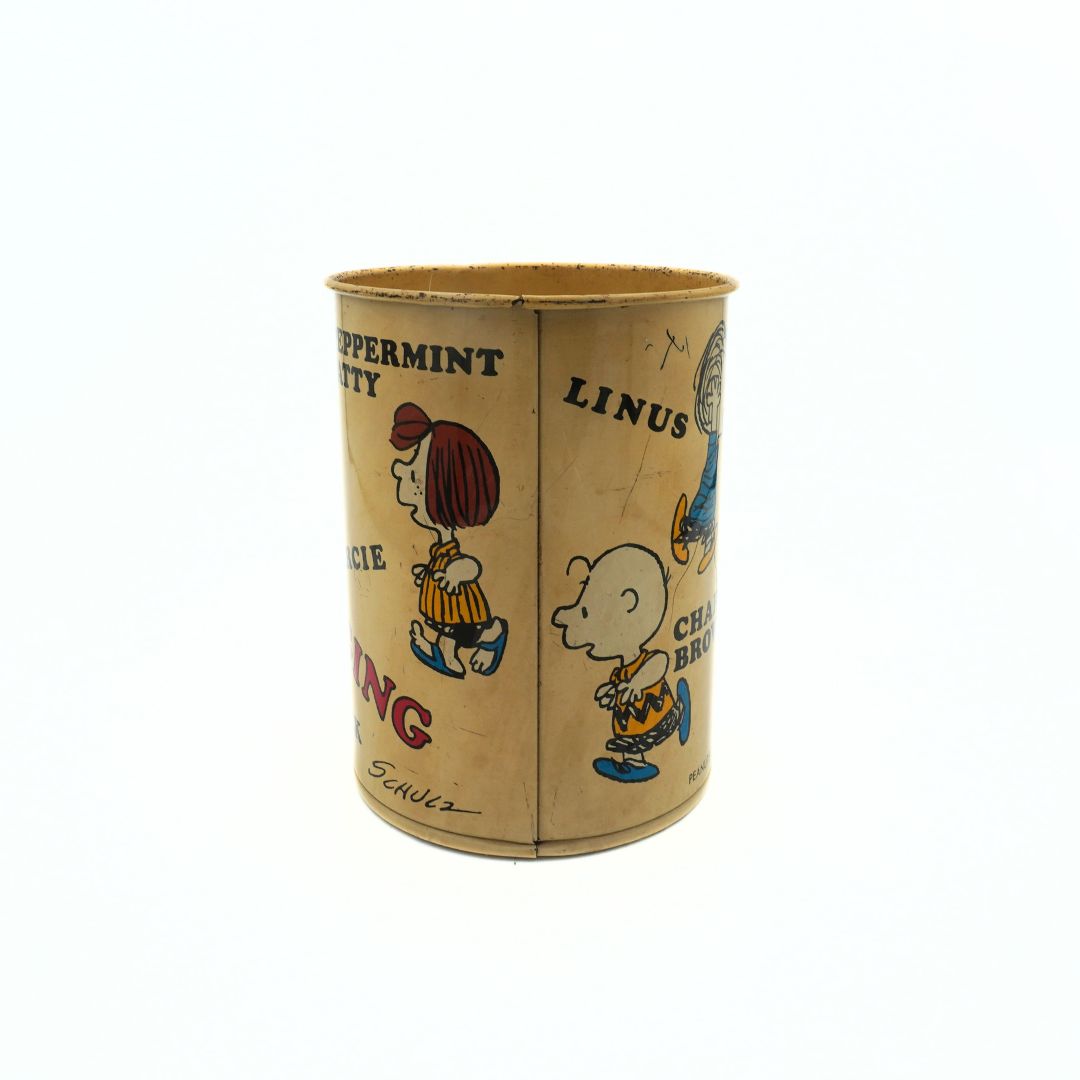 1971 Snoopy and Friends tin with multiple characters around the outside, visible here Charlie Brown and Peppermint Patty
