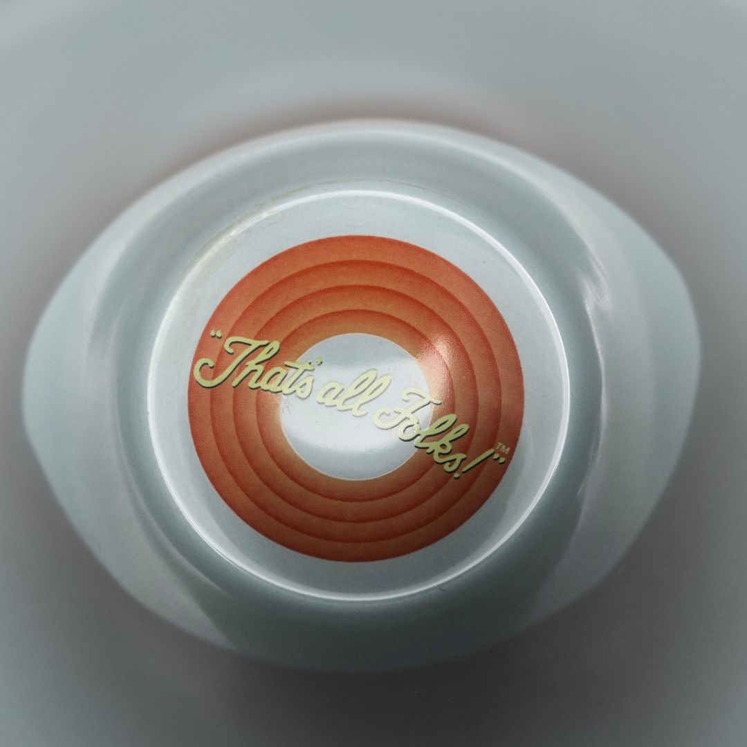 Inside of a 1999 Bugs Bunny Mug with the Warner Bros cartoon slogan at the bottom