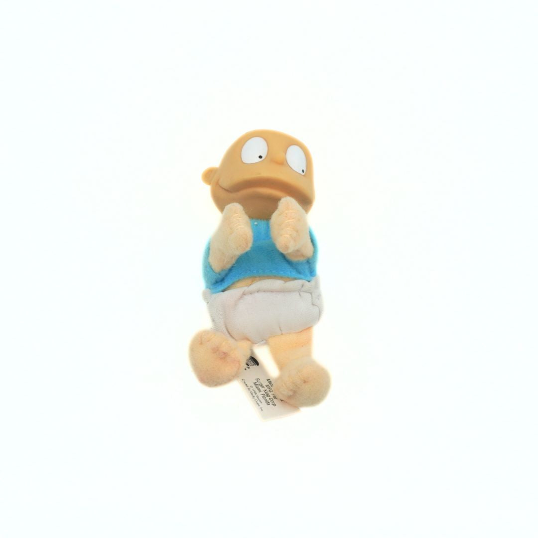A 90s Tommy Rugrats toy with a solid plastic head and a soft plush body