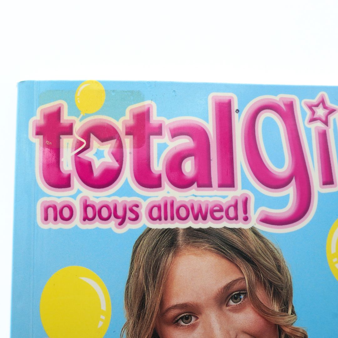 Book cover of a Total Girl cookbook showing sticker residue