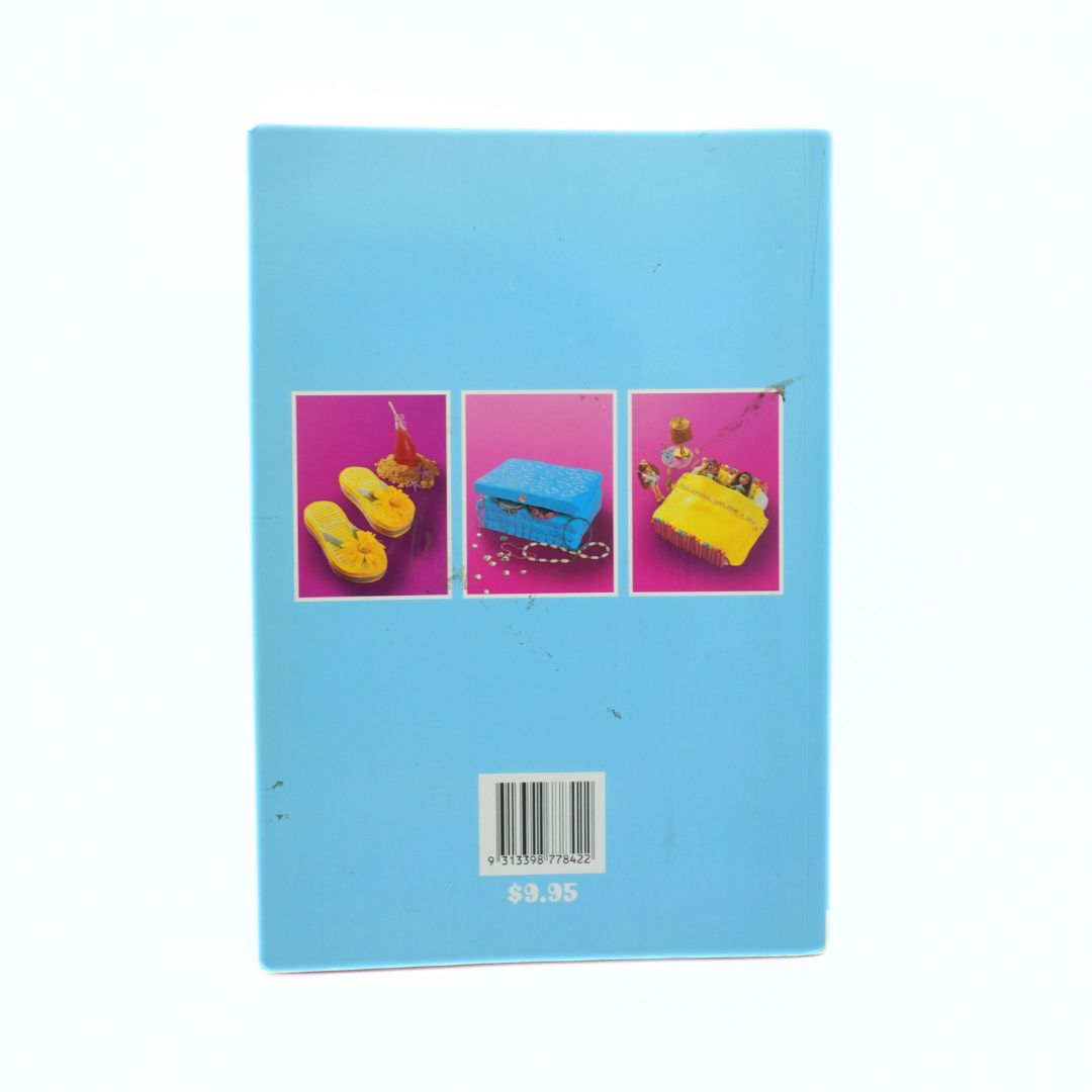 Blue cookbook with colourful cakes on a white background