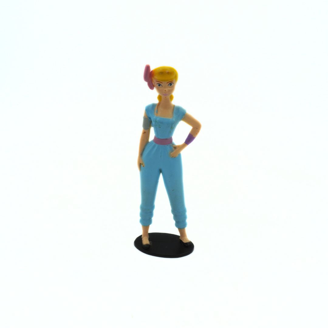 Toy figure of a character in a blue outfit with a white background