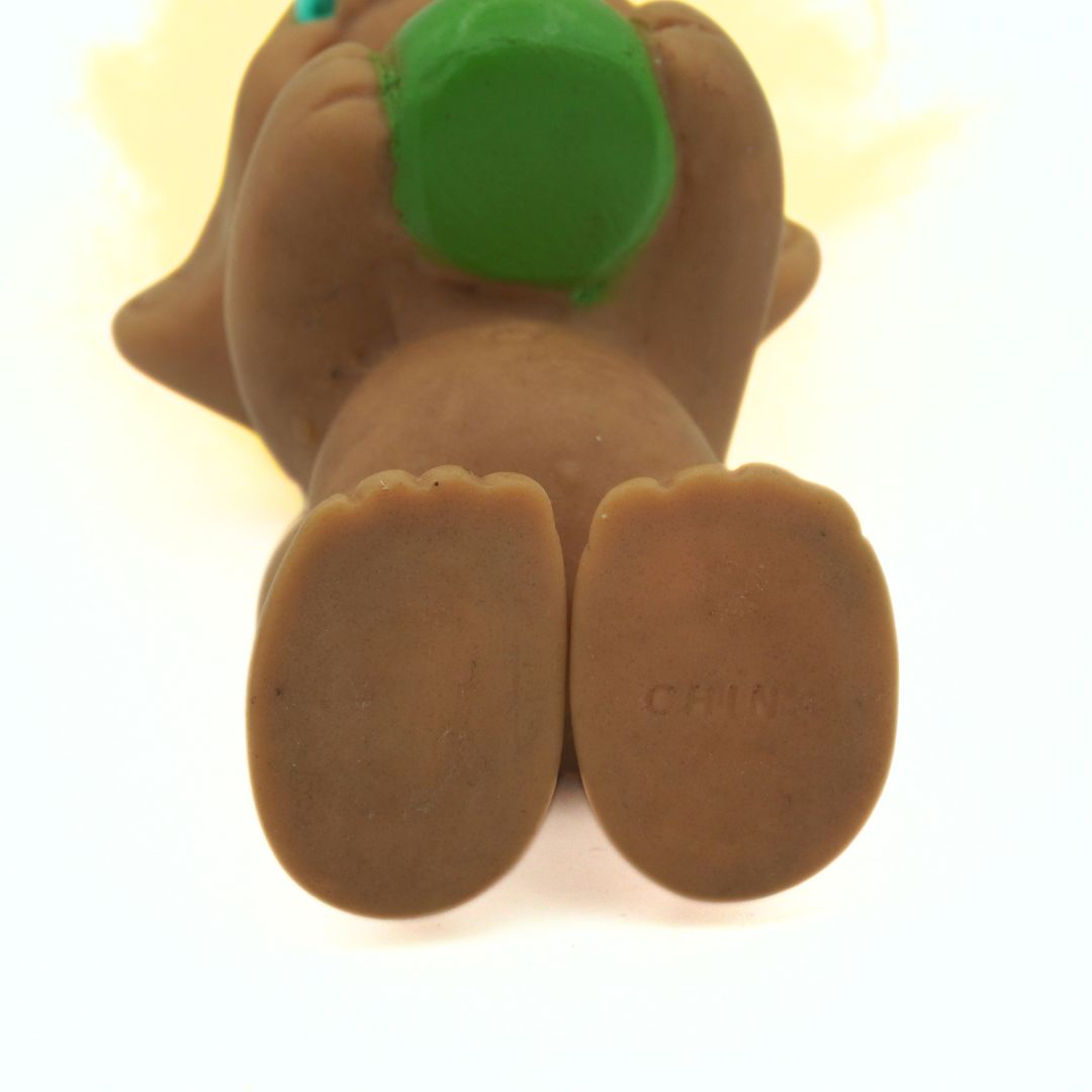 Underside of a vintage pot of gold themed troll with yellow hair