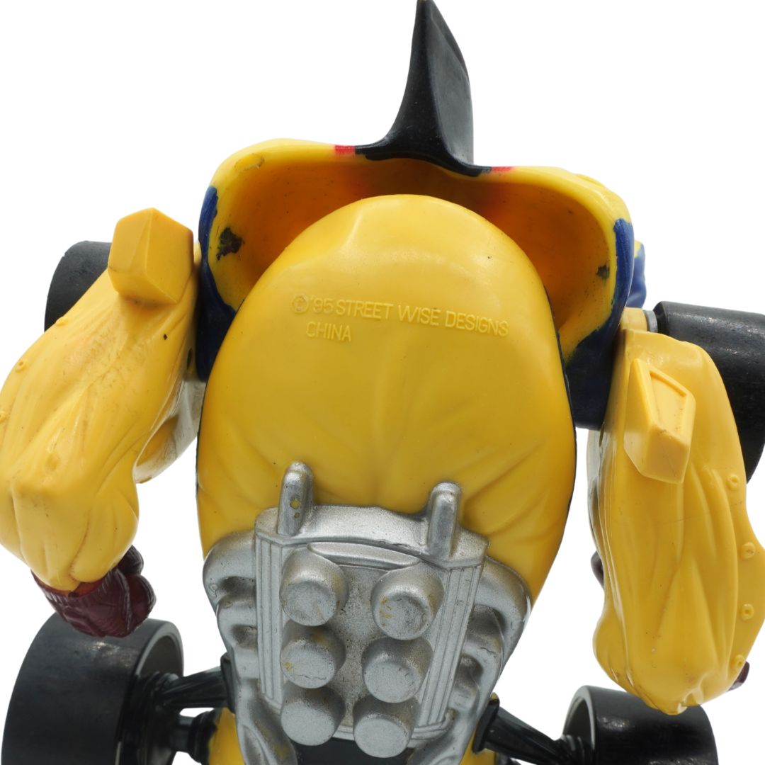 Close-up of a yellow robot toy with a white background