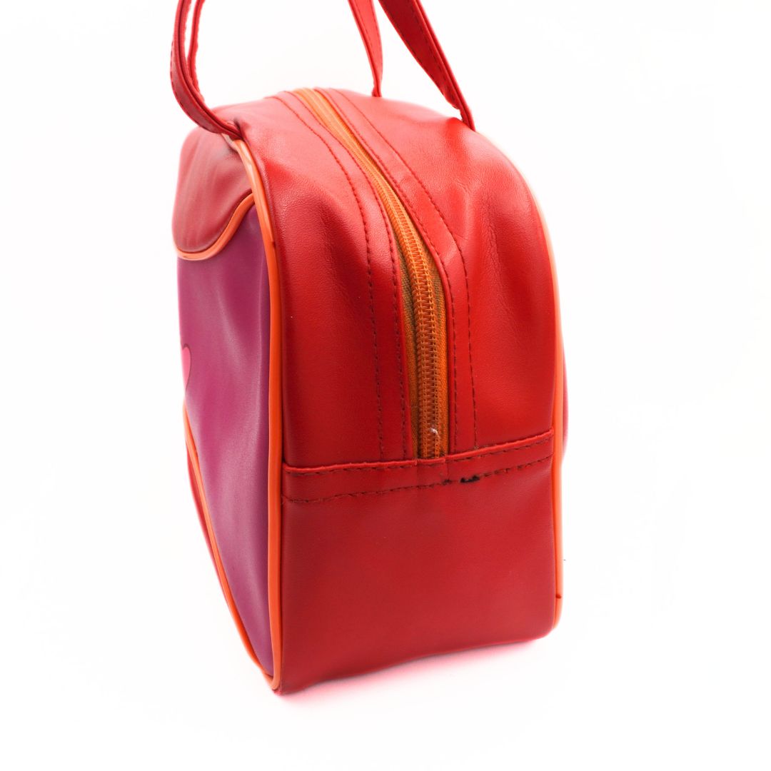 Side on picture of a vintage Tweety Bird bowling bag with a red and pink colour palette