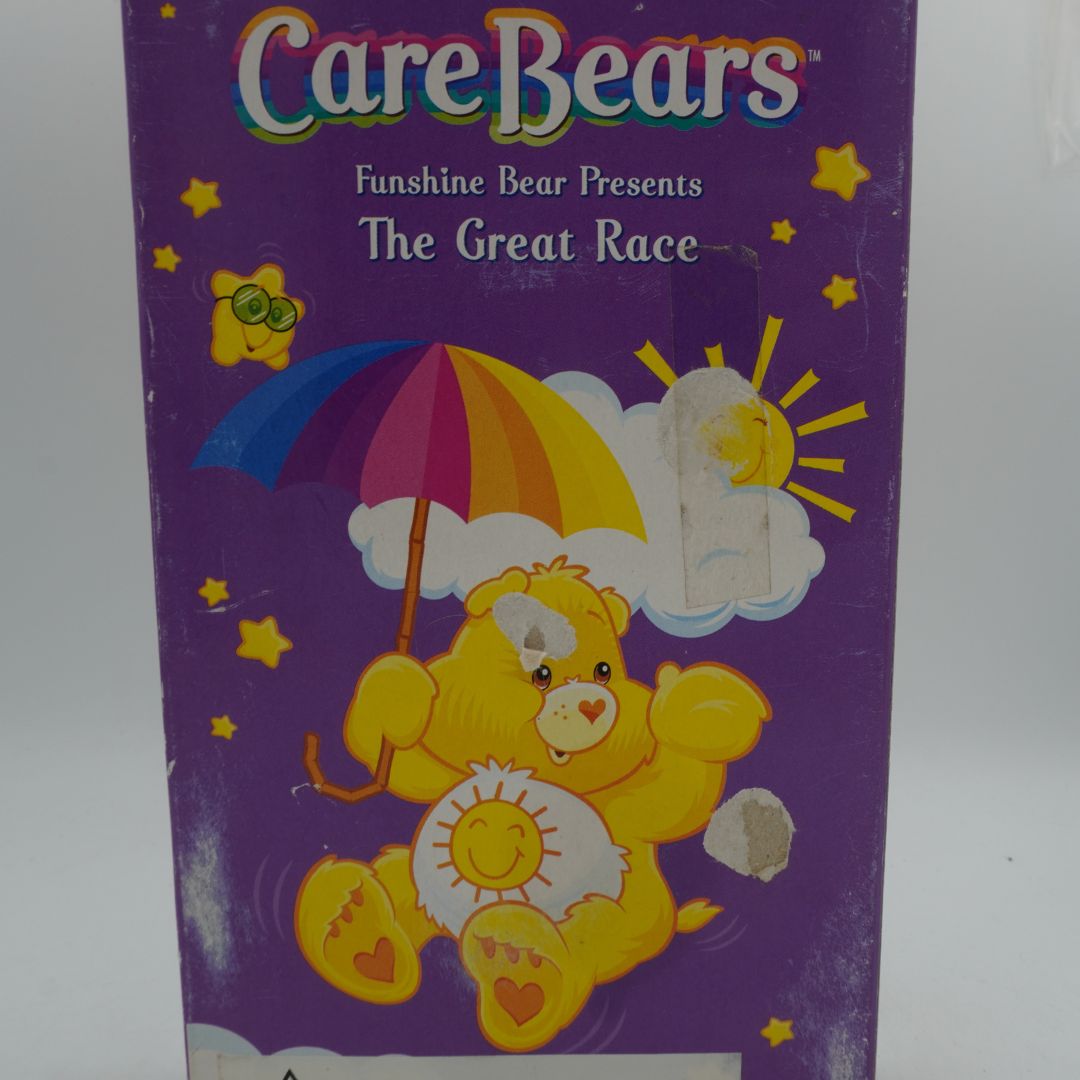 VHS cover of 'The Great Race' featuring a Care Bear with an umbrella on a purple background