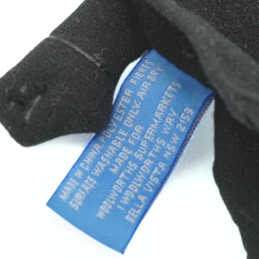 Black Vader toy with a blue label on a white background