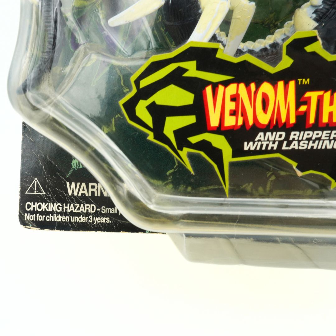 Creasing to the corner of a vintage 1997 Venom-The Symbiote toy in its original packaging