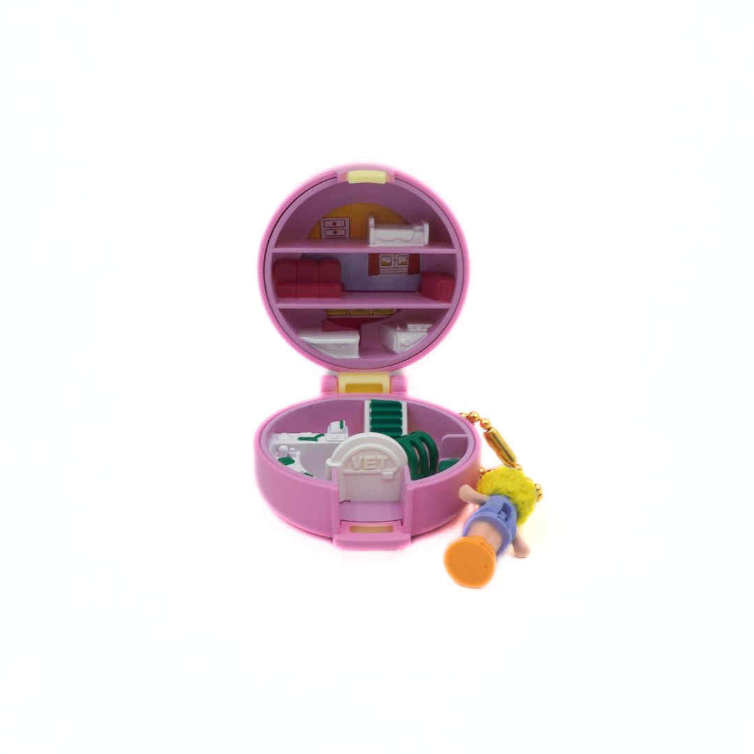 Mini pink Polly Pocket toy with a vet scene
