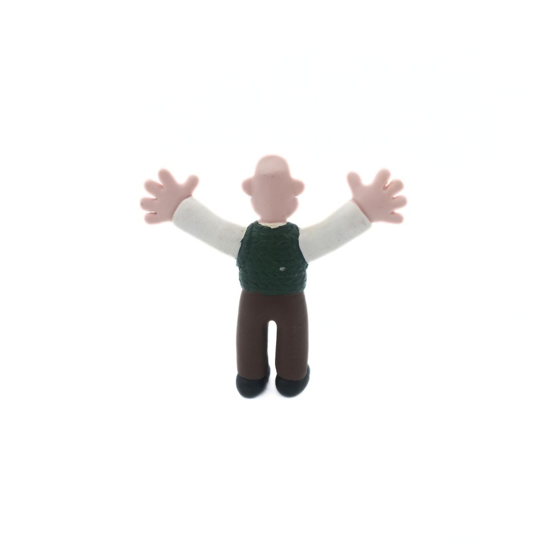 Back of a vintage Wallace & Gromit figure of Wallace wearing a green vest and brown pants