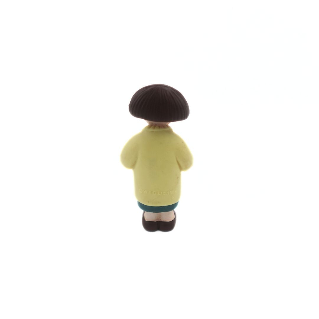 A mini figure of the Wallace & Gromit figure Wendolene Ramsbottom wearing a yellow cardigan and a green dress