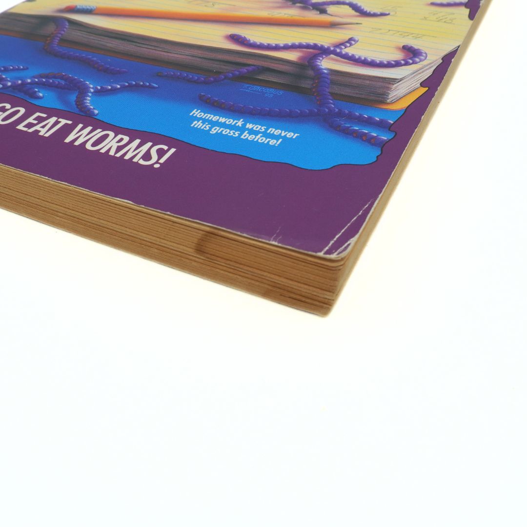 Close-up of a book with a purple cover and text, featuring a blue liquid and purple strings.