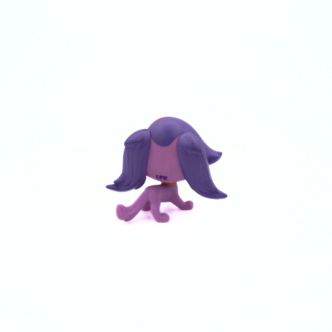 Purple figurine with long hair on a white background