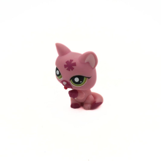 Pink toy figure with green eyes on a white background