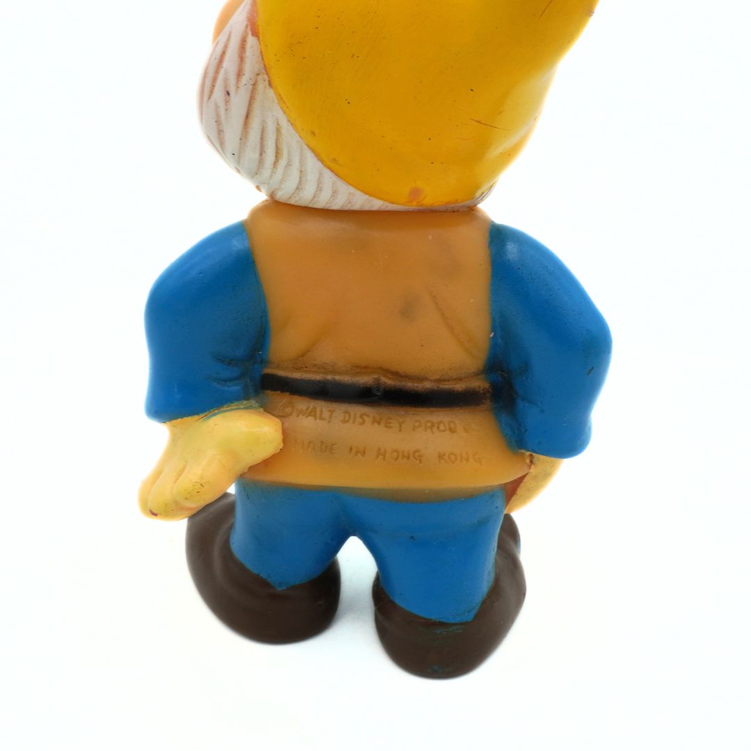 Vintage plastic figure of a character from Disney, showing the back with text.
