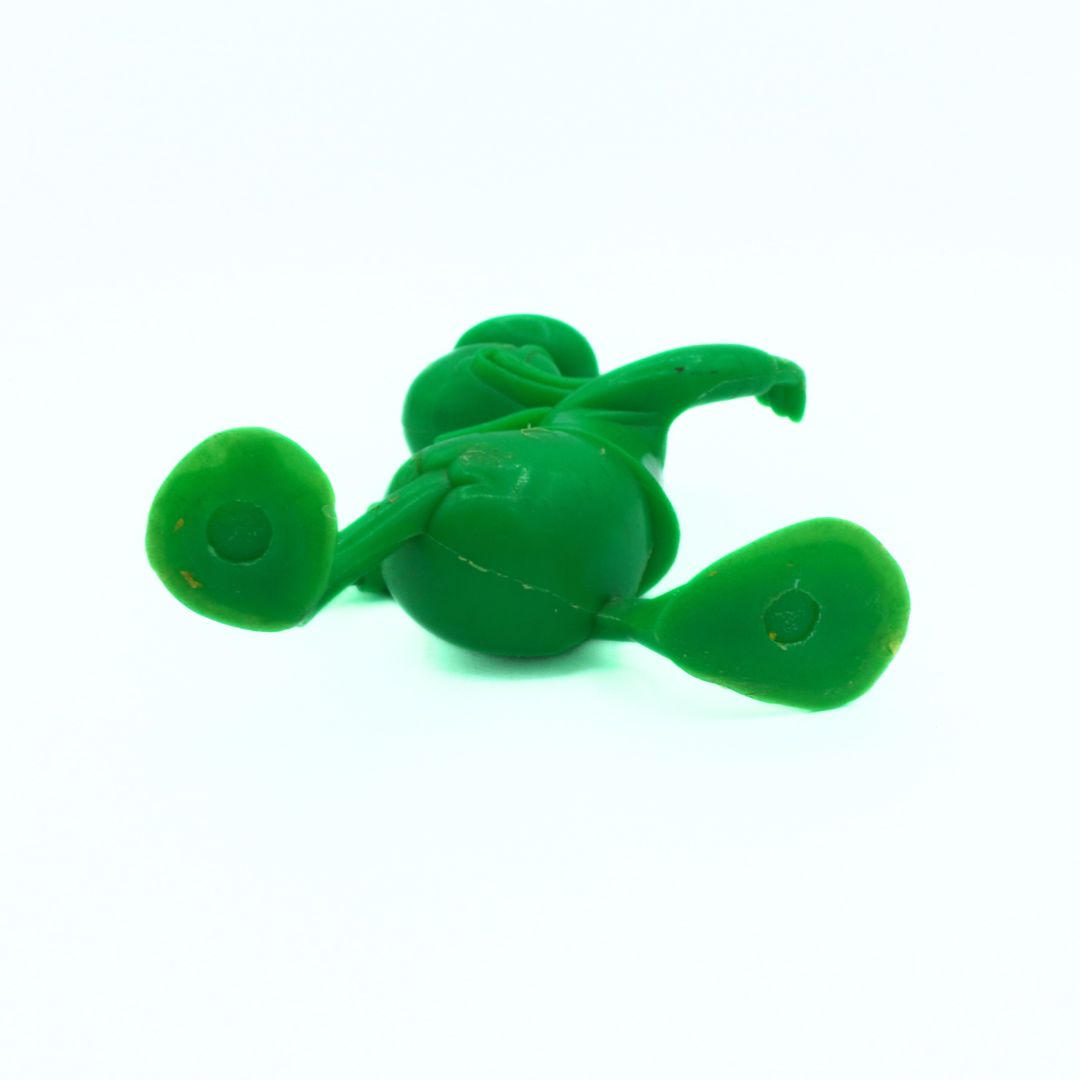 Green plastic duck on a white background