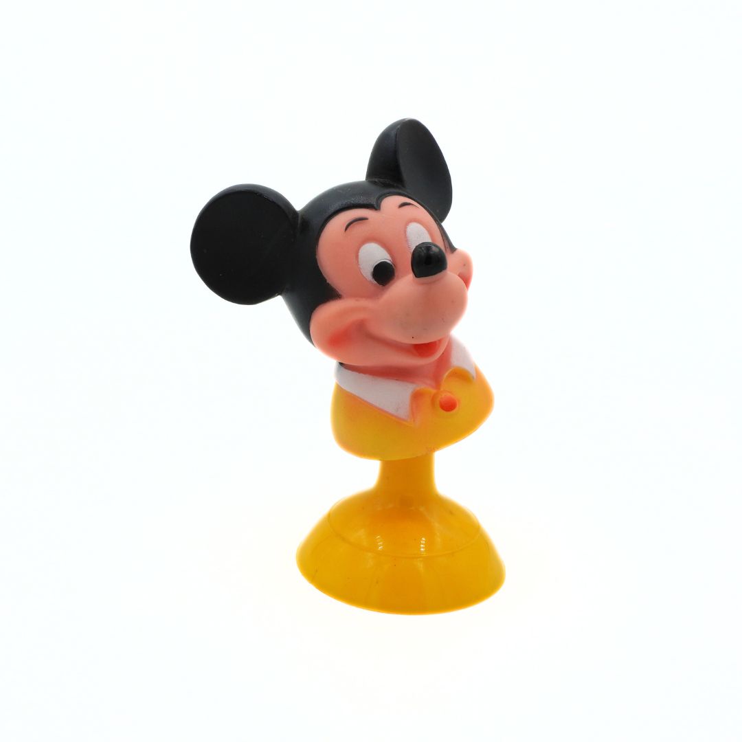 Toy figure of a cartoon character with a yellow base on a white background