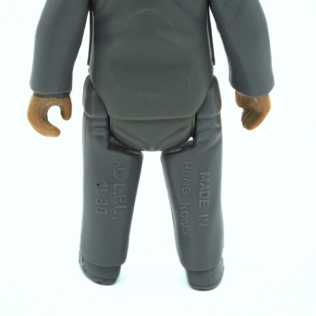 Gray action figure with visible branding on a white background